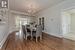 Dining area with a notable chandelier, hardwood / wood-style flooring, french doors, and ornamental molding