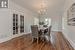 Dining area with crown molding, dark hardwood / wood-style floors, a notable chandelier, and french doors