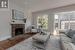 Living room with a fireplace and wood-type flooring