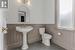 Bathroom featuring sink, toilet, and tile patterned flooring