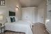 Bedroom featuring a closet, vaulted ceiling, and hardwood / wood-style flooring