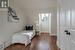 Bedroom with hardwood / wood-style flooring and lofted ceiling