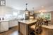 Kitchen featuring sink, stainless steel appliances, white cabinets, and a kitchen island