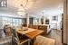 Dining area with dark hardwood / wood-style flooring and a notable chandelier