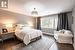 Bedroom featuring an inviting chandelier and dark hardwood / wood-style flooring