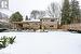 Snow covered property featuring a pergola