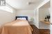 Bedroom featuring dark wood-type flooring and a closet