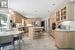 Kitchen view with island, quartz counters and stainless appliances