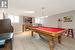 Games room with pool table, gas fireplace and vinyl flooring