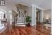 Foyer with crown molding and dark wood-type flooring