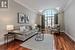 Living room featuring dark wood-type flooring, lofted ceiling, and crown molding