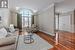 Living room featuring crown molding, lofted ceiling, and dark hardwood / wood-style floors