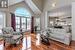 Living room with high vaulted ceiling, a chandelier, and light wood-type flooring