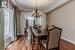 Dining room with an inviting chandelier, ornamental molding, and hardwood / wood-style floors