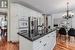 Kitchen featuring white cabinetry, a kitchen island, a chandelier, and stainless steel refrigerator with ice dispenser