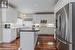 Kitchen featuring sink, white cabinetry, stainless steel appliances, a center island, and dark hardwood / wood-style flooring