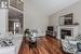 Living room with crown molding, dark hardwood / wood-style floors, and high vaulted ceiling