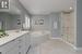 Bathroom with independent shower and bath, vanity, and tile patterned floors