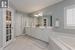 Bathroom with vanity, tiled tub, and tile patterned floors