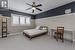 Carpeted bedroom featuring ceiling fan