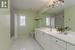 Full bathroom featuring shower / bathtub combination with curtain, vanity, toilet, and tile patterned floors