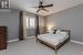 Bedroom with light colored carpet and ceiling fan