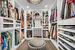 Walk in closet with a notable chandelier and dark hardwood / wood-style flooring