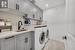 Clothes washing area featuring sink, cabinets, and independent washer and dryer