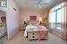 Bedroom featuring light carpet, ceiling fan, and baseboards