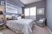 Bedroom featuring light colored carpet and baseboards