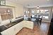 Kitchen featuring white cabinets, dishwasher, dark countertops, pendant lighting, and a sink