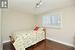 Bedroom with baseboards, dark wood finished floors, and track lighting