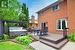 Wooden deck with outdoor dining space, a pergola, fence, and a hot tub