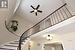 Staircase with ceiling fan, a high ceiling, and visible vents