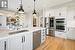 Chef's Renovated Kitchen with Quartz Counters Open to Bright Breakfast Area