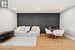Oversized Bedroom/Family Room with Hardwood Floor and Modern Accent Wall