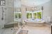 Stylish Primary Ensuite with a Jacuzzi Tub Surrounded by Panoramic Windows
