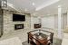 Oversized Recreation Room Features an Electric Fireplace and a Wet Bar