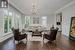 Inviting Living Room with Hardwood Flooring and Crown Moldings