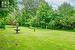 Beautifully Maintained One Acre, Tree-Lined Property with Gorgeous Flower Beds