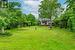 Beautifully Maintained One Acre, Tree-Lined Property with Gorgeous Flower Beds