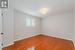 Second Bedroom with a Hardwood Floor and California Shutters