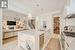 The Gourmet Kitchen Features Custom White Cabinetry