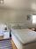 Bedroom with a textured ceiling and light hardwood / wood-style flooring