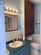 Bathroom featuring tile walls, tile patterned floors, a shower with curtain, vanity, and toilet