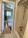 Bathroom featuring wood-type flooring, a textured ceiling, vaulted ceiling, and shower / tub combo