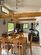 Dining room featuring a wealth of natural light, lofted ceiling, light tile patterned floors, and ceiling fan