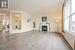 Unfurnished living room featuring ornate columns and light hardwood / wood-style flooring