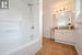 Bathroom with tile patterned flooring, vanity, and washtub / shower combination