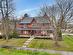 View of front of house featuring a porch and a front lawn